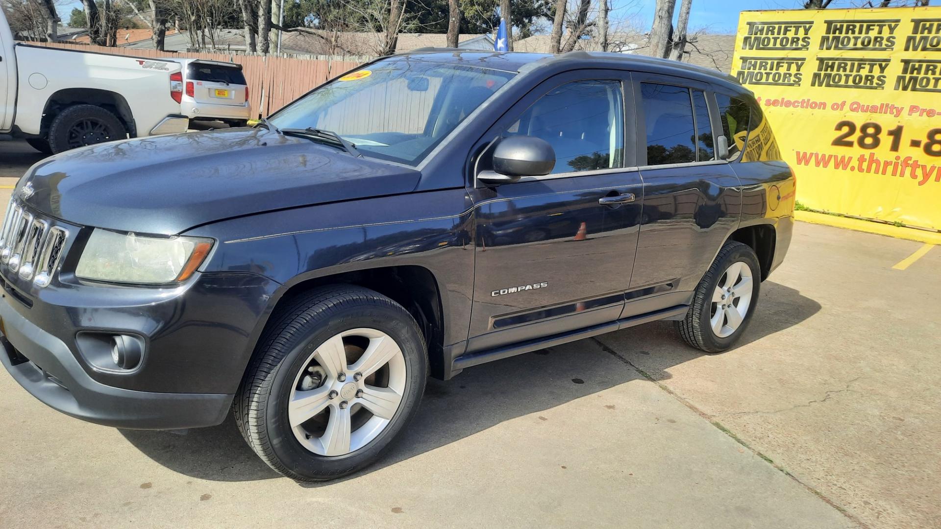 2014 Jeep Compass (1C4NJDBBXED) , located at 16710 Clay Rd., Houston, TX, 77084, (281) 859-7900, 29.834864, -95.656166 - Photo#1